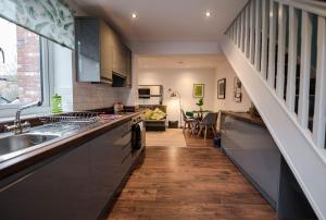 a kitchen with a sink and a counter top at Air Host and Stay - Apartment 5 Broadhurst Court sleeps 6 minutes from town centre in Stockport