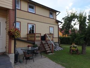 a house with a patio and a table and chairs at Aikarali Home Accommodation in Haapsalu