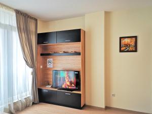 a entertainment center with a television in a room at Mladost Apartments Sofia in Sofia