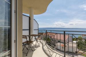 a balcony with a view of the ocean at Luxury Apartments with Private Pool and Sauna or with jacuzzi near Split , Sea View in Podstrana