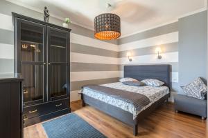 a bedroom with a bed and a chair at Luxury Apartments with Private Pool and Sauna or with jacuzzi near Split , Sea View in Podstrana