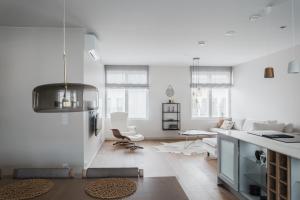 a kitchen and living room with white walls at Luxury Apartment Hovi in Naantali