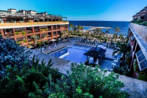 an aerial view of a resort with a swimming pool and the ocean at Gran Hotel Guadalpín Banus in Marbella