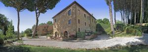 a large stone building with trees in front of it at Il Lebbio Agriresort in Montaione