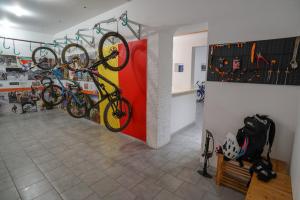 a room with bikes hanging on a wall at Hotel San Pietro Palace in Finale Ligure