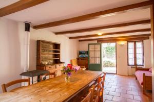 a kitchen with a wooden counter with a vase of flowers at L'Oubradou Mas de charme shared pool in Provence nature and calm in Flayosc