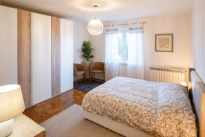 a bedroom with a bed and a table and a window at Le Radici in Isola del Piano