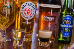 a group of beer bottles and glasses on a table at The Griffin Belle Hotel Vauxhall in London