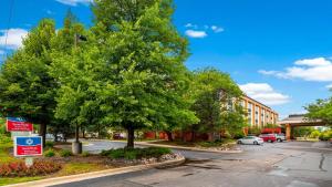a street with a tree and a parking lot at SureStay Plus Hotel by Best Western Chicago Lombard in Lombard