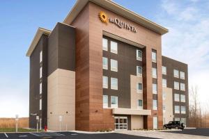 a building with a sun on top of it at La Quinta by Wyndham Buffalo Amherst in Amherst