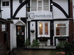 a building with a sign on the front of it at Cornerstone B&B in Ashford