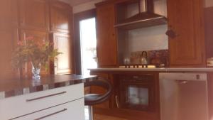 a kitchen with wooden cabinets and a counter top at VILLA Zaphira in Gujan-Mestras