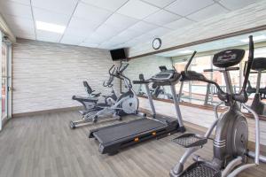 a gym with several cardio machines in a room at Ramada by Wyndham Tampa Westshore Airport South in Tampa