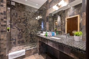 La salle de bains est pourvue d'un lavabo et d'un grand miroir. dans l'établissement Premium apartament & Penthouse - Center, à Krasnodar