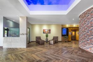 an empty lobby with chairs and a brick wall at Ramada by Wyndham Tampa Westshore Airport South in Tampa