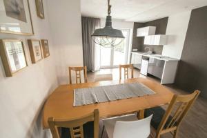 a kitchen and dining room with a wooden table and chairs at Apartment Unimix in Liptovský Mikuláš