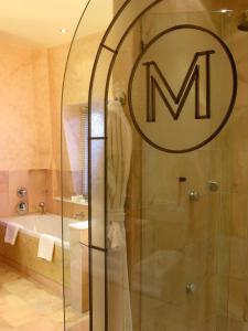 a bathroom with a shower with a sign on the door at The Mandeville Hotel in London