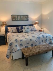 a bedroom with a bed with a sign on the wall at Bahama Breeze #4 Sea Dancer Condos in South Padre Island +48 photos