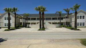 un gran edificio con palmeras en un aparcamiento en Bahama Breeze #4 Sea Dancer Condos en South Padre Island