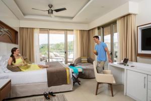 a man and a woman in a hotel room at Hideaway at Royalton Saint Lucia, An Autograph Collection All-Inclusive Resort, Adults Only in Gros Islet