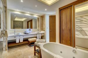 a bathroom with two sinks and a bath tub at Royalton Saint Lucia, An Autograph Collection All-Inclusive Resort in Gros Islet