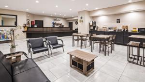 a restaurant with tables and chairs and a counter at SureStay Hotel by Best Western Orange in Orange