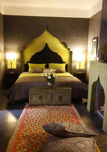 a bedroom with a large bed with a large headboard at Dar Beija in Marrakech