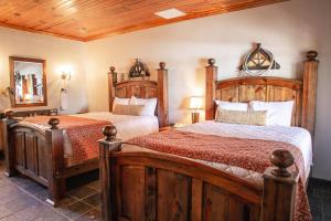 a bedroom with two beds and a mirror at Lajitas Golf Resort in Terlingua