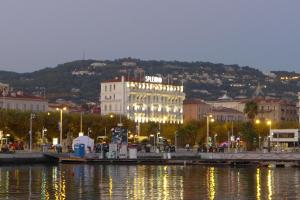 a city with a large building on the side of the water at Hotel Splendid in Cannes