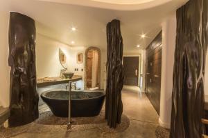 a bathroom with a large black tub in a room at Nayara Hangaroa in Hanga Roa