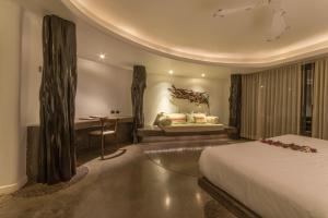 a hotel room with a bed and a table and a desk at Nayara Hangaroa in Hanga Roa