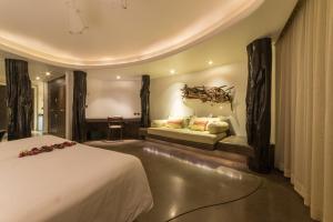 a hotel room with a bed and a couch at Nayara Hangaroa in Hanga Roa