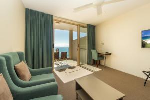 a living room with a couch and a table at The Dorsal Boutique Hotel in Forster