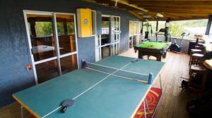 a room with a ping pong table in a house at Tombstone Motel, Lodge & Backpackers in Picton
