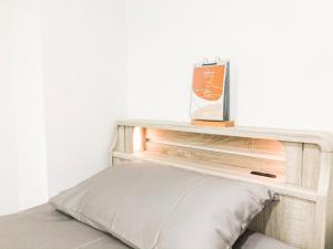 a wooden shelf above a bed with a pillow at ZAITO Tokyo Chitose Accommodation 森下駅から徒歩6分 in Tokyo