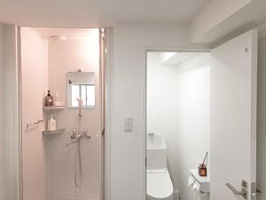 a white bathroom with a shower and a toilet at ZAITO Tokyo Chitose Accommodation 森下駅から徒歩6分 in Tokyo