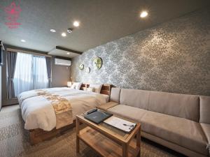 a hotel room with a bed and a couch at Stay SAKURA Kyoto Gion North in Kyoto
