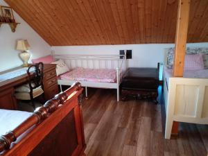 a bedroom with a bed and a chair in a room at Cozy family house in Odorín