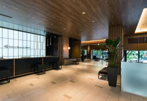 a lobby with a waiting area in a building at Daiwa Roynet Hotel Hakata Reisen PREMIER - former Daiwa Roynet Hotel Hakata Reisen in Fukuoka