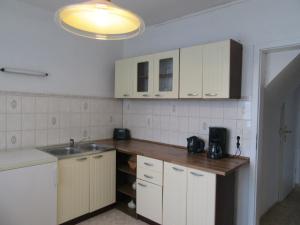 a kitchen with white cabinets and a sink at Haus Hasenmüller in Schmiedefeld am Rennsteig