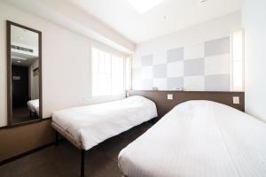Postel nebo postele na pokoji v ubytování Hotel Sunlite Shinjuku