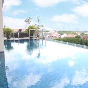 a swimming pool on the roof of a building at Swiss-Belinn Manyar in Surabaya