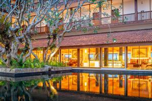 a building with a pool in front of it at Cinnamon Bentota Beach - Signature Selection in Bentota