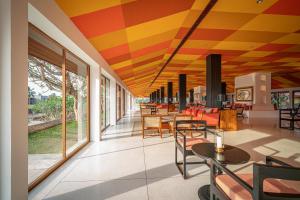 a restaurant with a colorful ceiling and tables and chairs at Cinnamon Bentota Beach - Signature Selection in Bentota