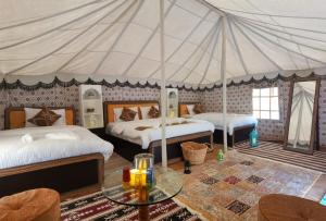 1 Schlafzimmer mit 2 Betten und einem Zelt in der Unterkunft Alsarmadi Desert Camp in Shāhiq