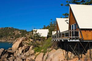 a house with a view of the ocean and mountains at Base Magnetic Island in Nelly Bay