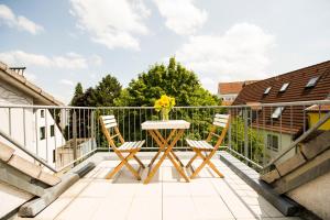 a table and two chairs on a balcony at City Center Apartments in Kirchheim unter Teck