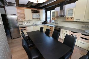a kitchen with a black table and black chairs at Hof Zuidvliet in Wolphaartsdijk