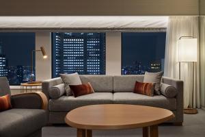 a living room with a couch and a table at Keio Plaza Hotel Tokyo in Tokyo