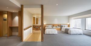 a hotel room with two beds and a bathroom at Keio Plaza Hotel Tokyo in Tokyo